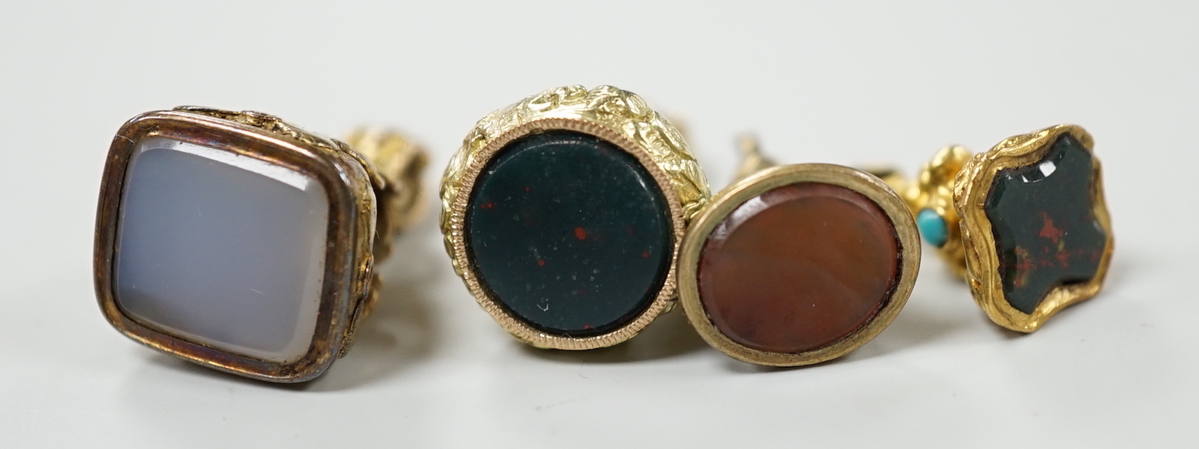 A group of eight assorted 19th century yellow metal overlaid and chalcedony or citrine set fob seals, including two colour, enamelled and turquoise set, largest 20mm.